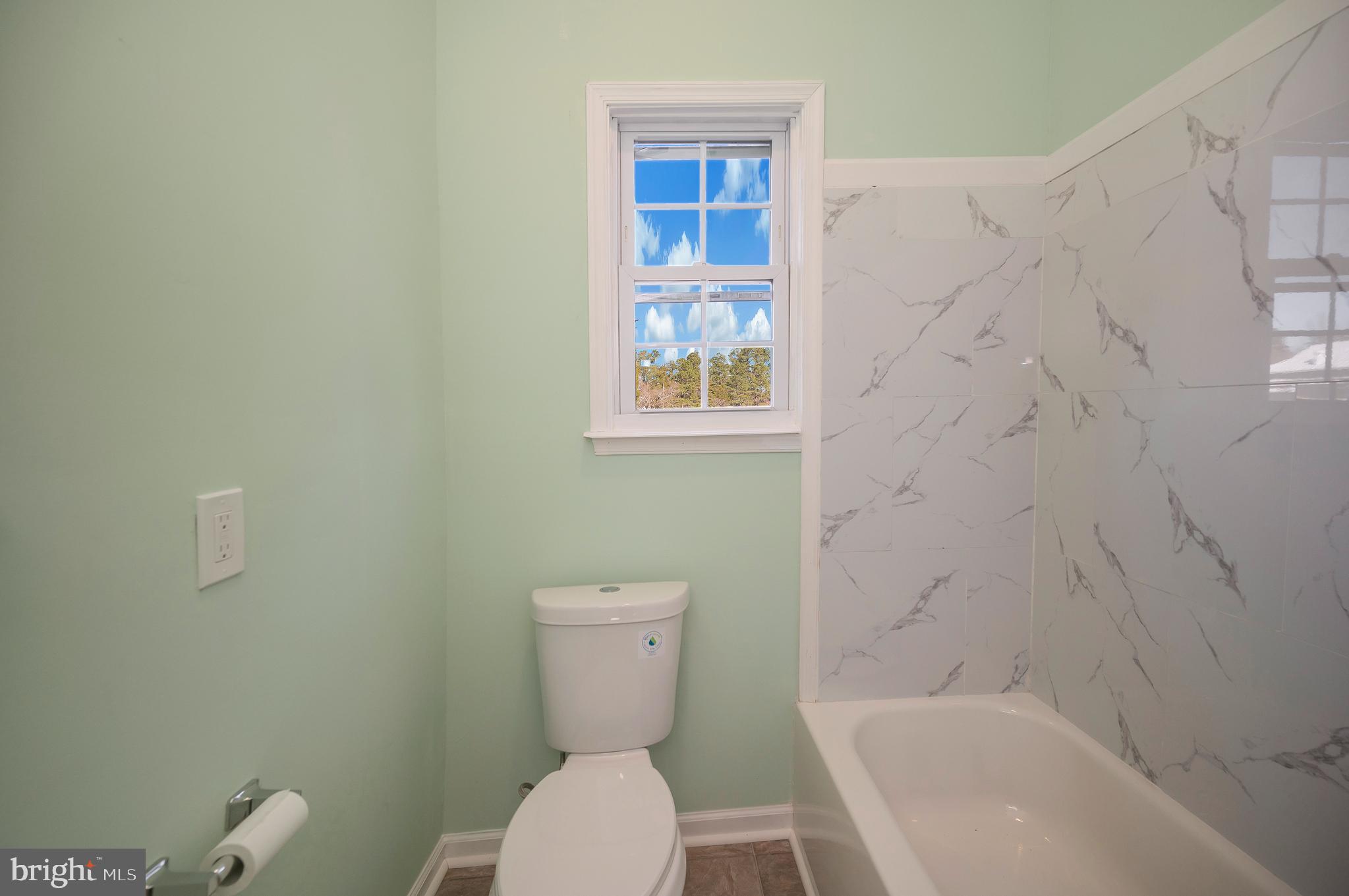 26348 Sunshine Road Ruther Glen, VA 22546 - Photo 12 of 56 a white toilet sitting next to a bath tub