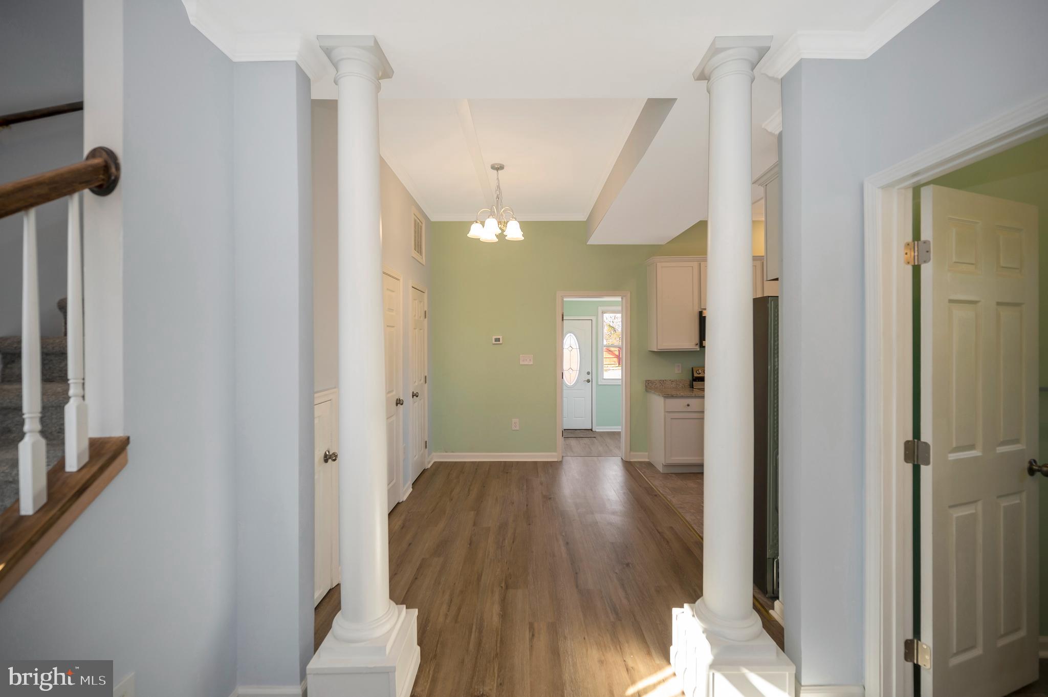 26348 Sunshine Road Ruther Glen, VA 22546 - Photo 13 of 56 a view of a hallway with wooden floor and a bathroom