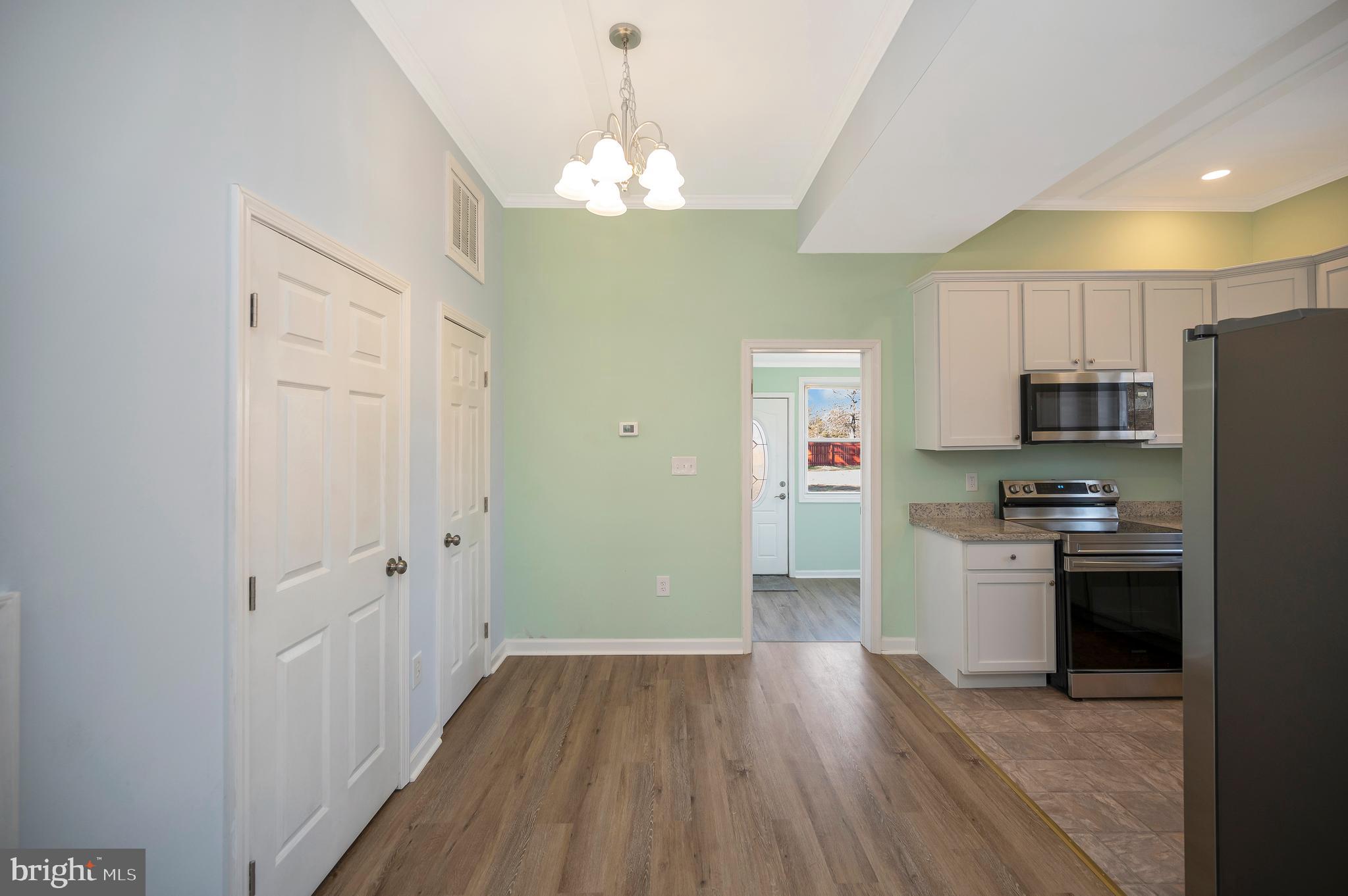 26348 Sunshine Road Ruther Glen, VA 22546 - Photo 14 of 56 a kitchen with stainless steel appliances granite countertop a refrigerator a stove top oven a sink dishwasher and wooden floor