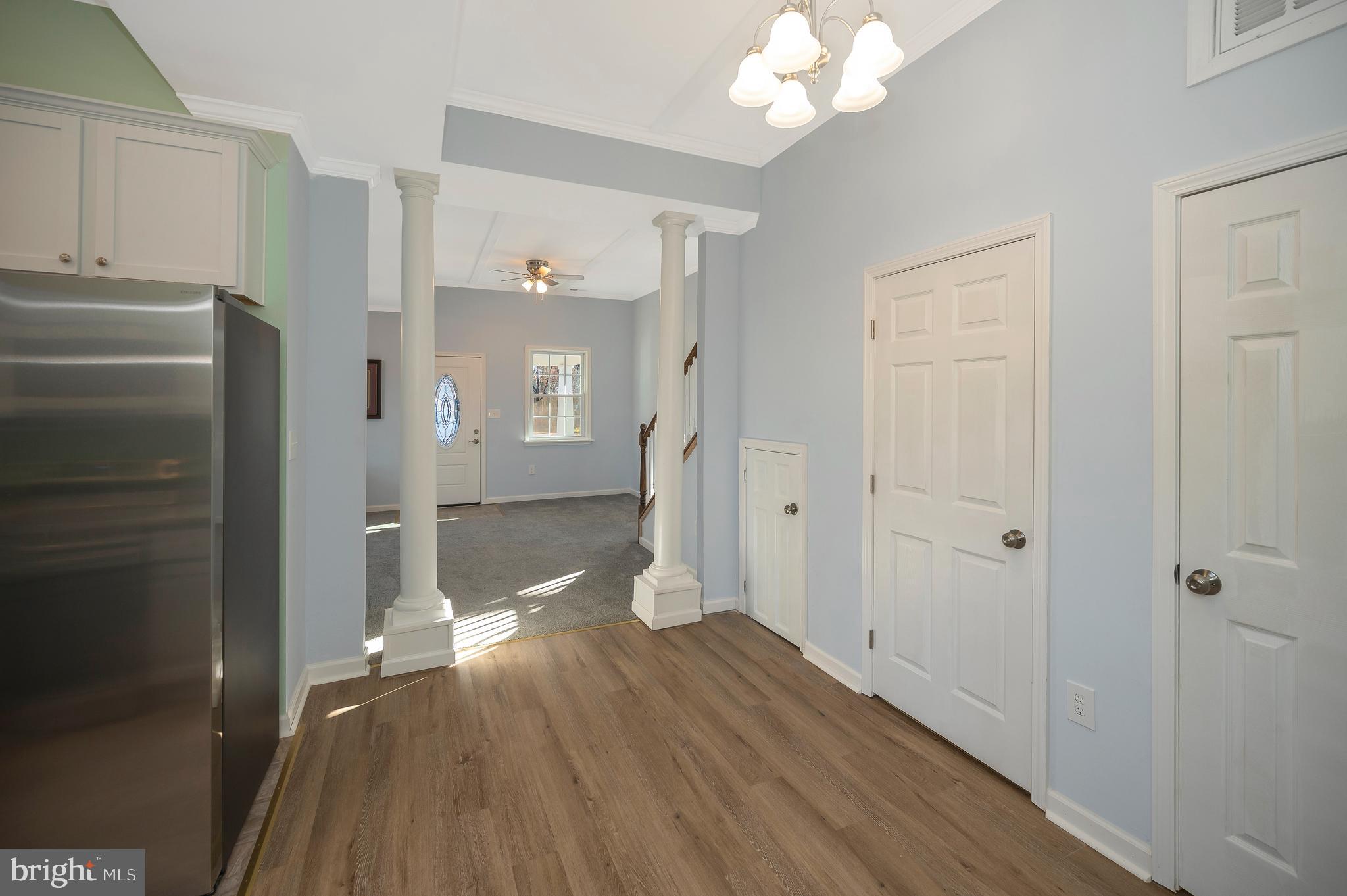 26348 Sunshine Road Ruther Glen, VA 22546 - Photo 16 of 56 a view of a hallway with wooden floor and staircase