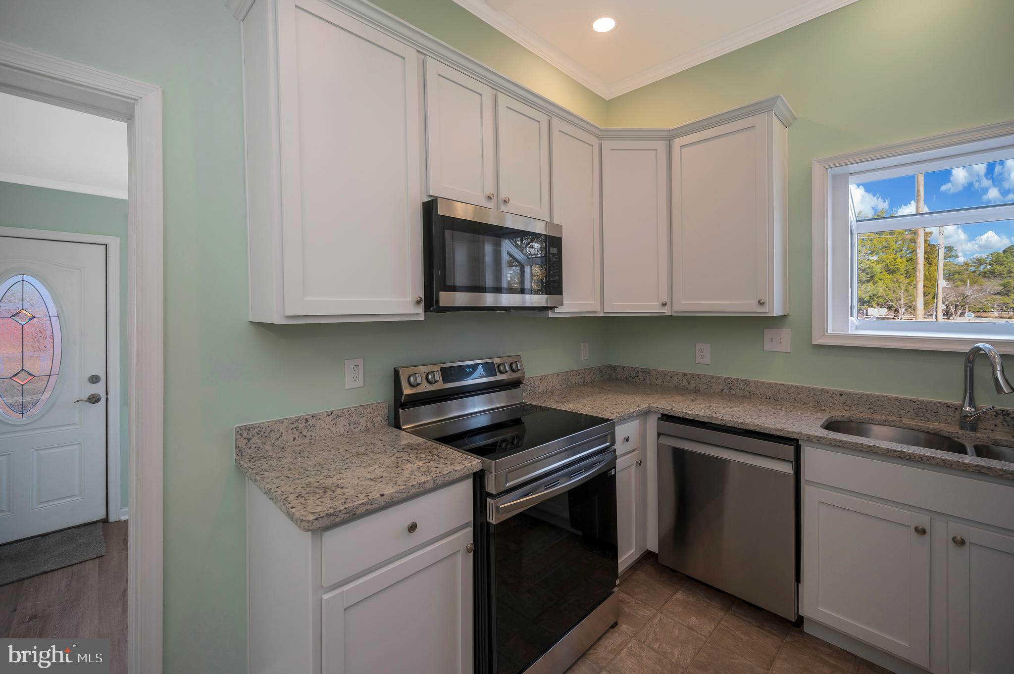 26348 Sunshine Road Ruther Glen, VA 22546 - Photo 18 of 56 a kitchen with appliances cabinets and a sink