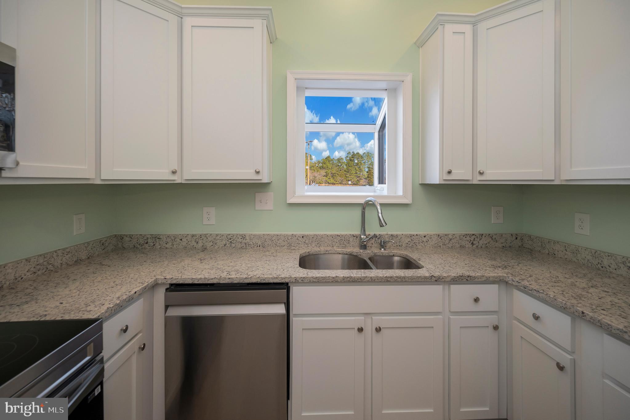 26348 Sunshine Road Ruther Glen, VA 22546 - Photo 19 of 56 a kitchen with granite countertop white cabinets and a sink