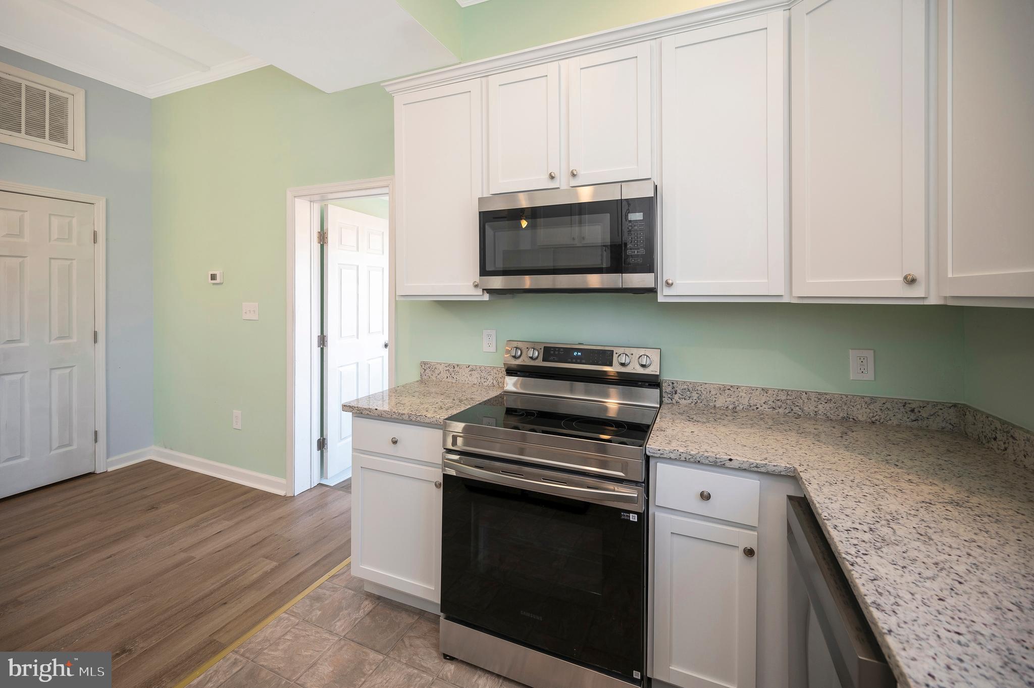 26348 Sunshine Road Ruther Glen, VA 22546 - Photo 21 of 56 a kitchen with granite countertop cabinets stainless steel appliances and wooden floor