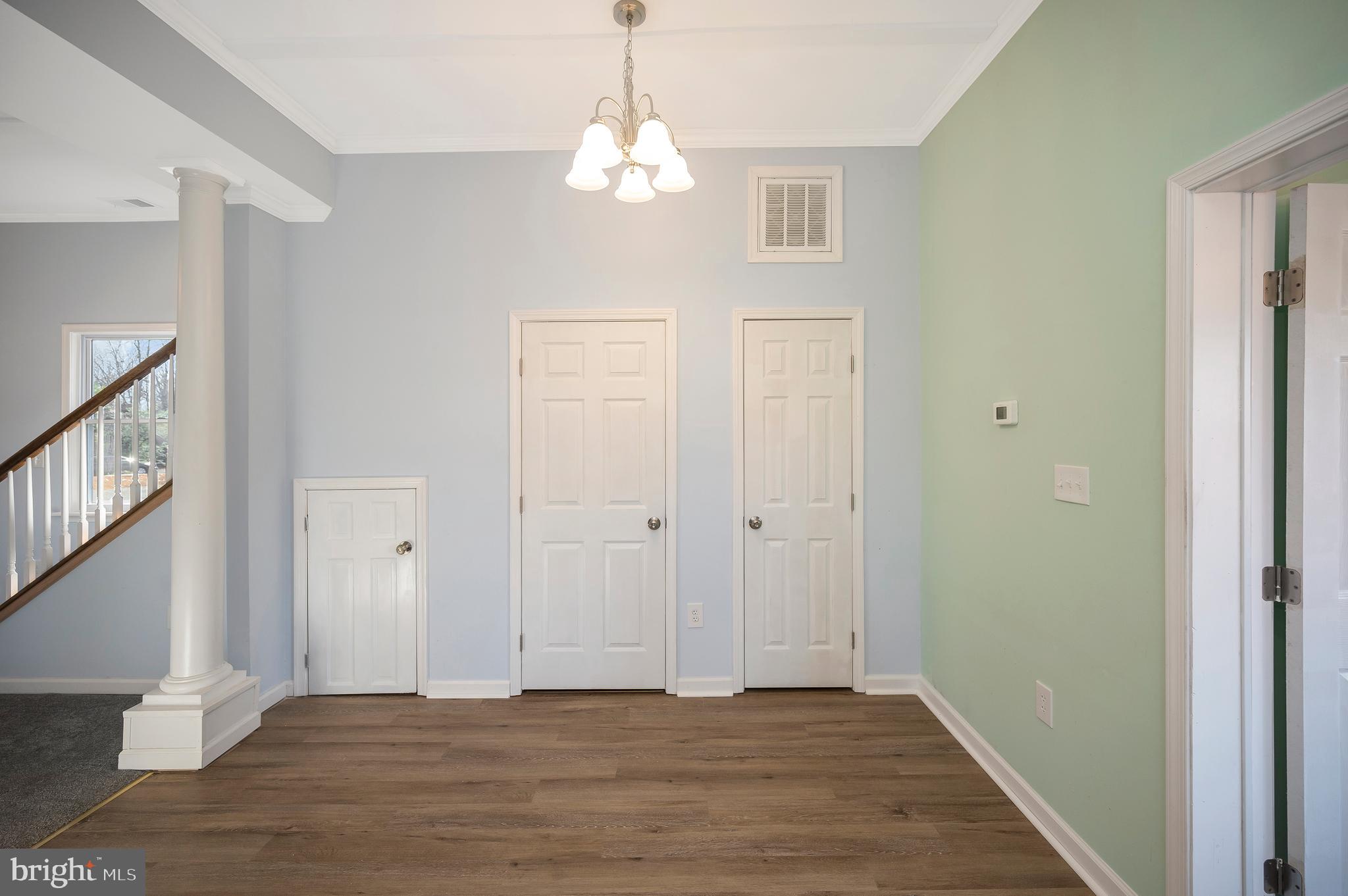 26348 Sunshine Road Ruther Glen, VA 22546 - Photo 23 of 56 a view of an empty room with wooden floor and staircase