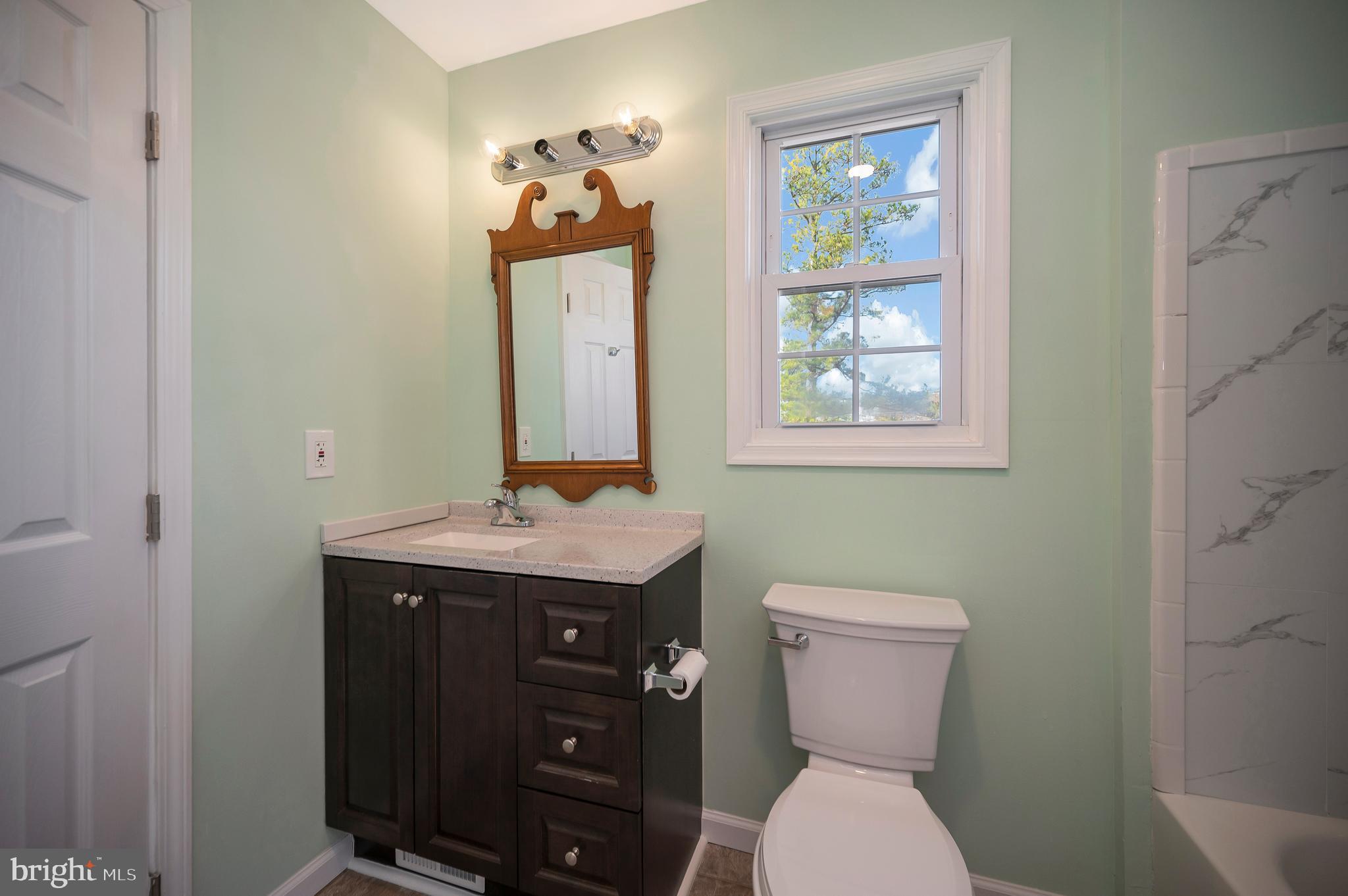 26348 Sunshine Road Ruther Glen, VA 22546 - Photo 33 of 56 a bathroom with a toilet sink and mirror