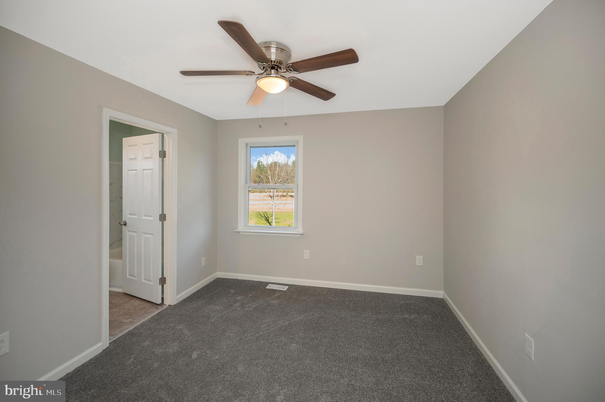 26348 Sunshine Road Ruther Glen, VA 22546 - Photo 35 of 56 an empty room with a window and a fan