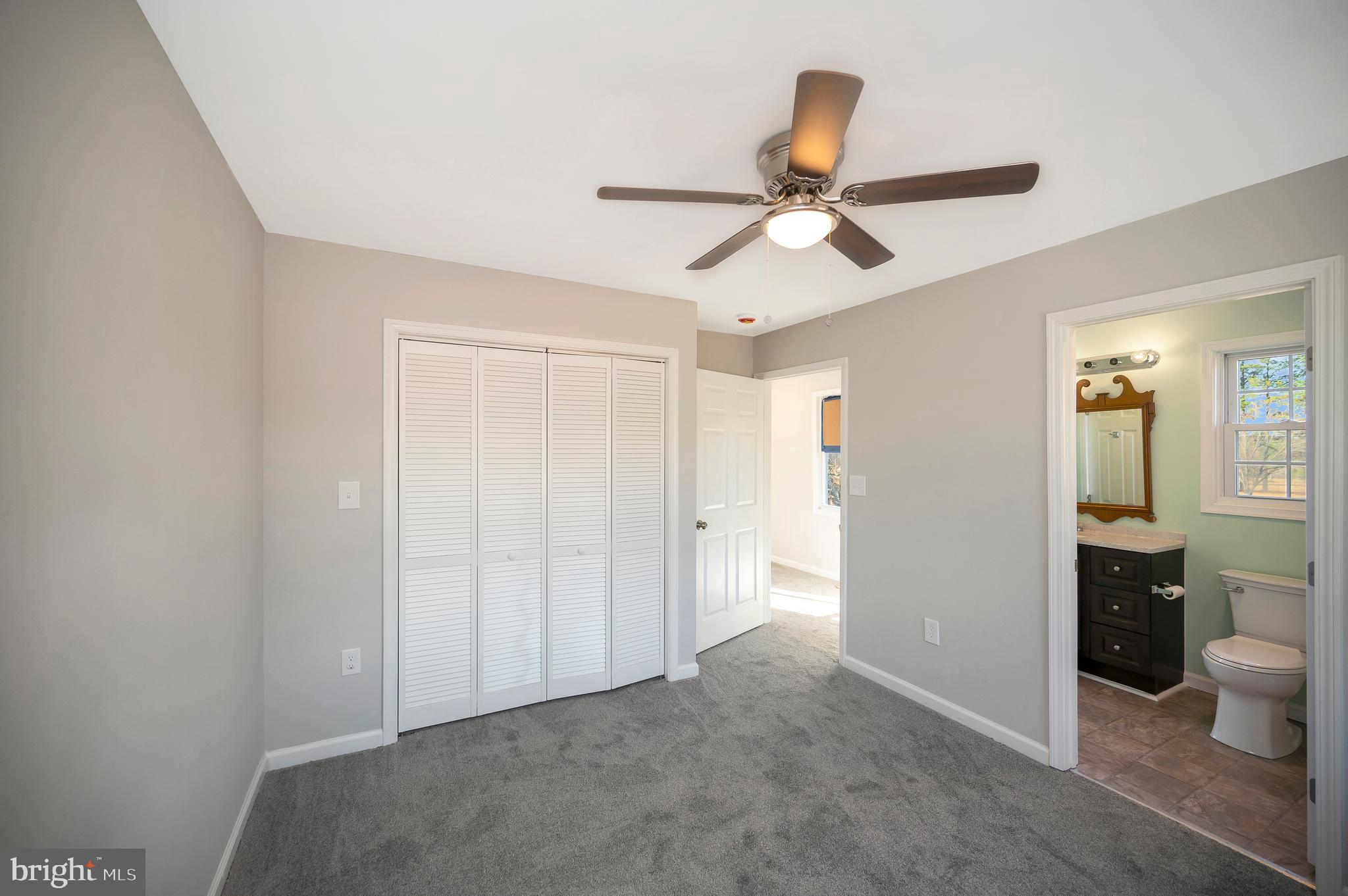 26348 Sunshine Road Ruther Glen, VA 22546 - Photo 36 of 56 a view of a livingroom with a ceiling fan and a window