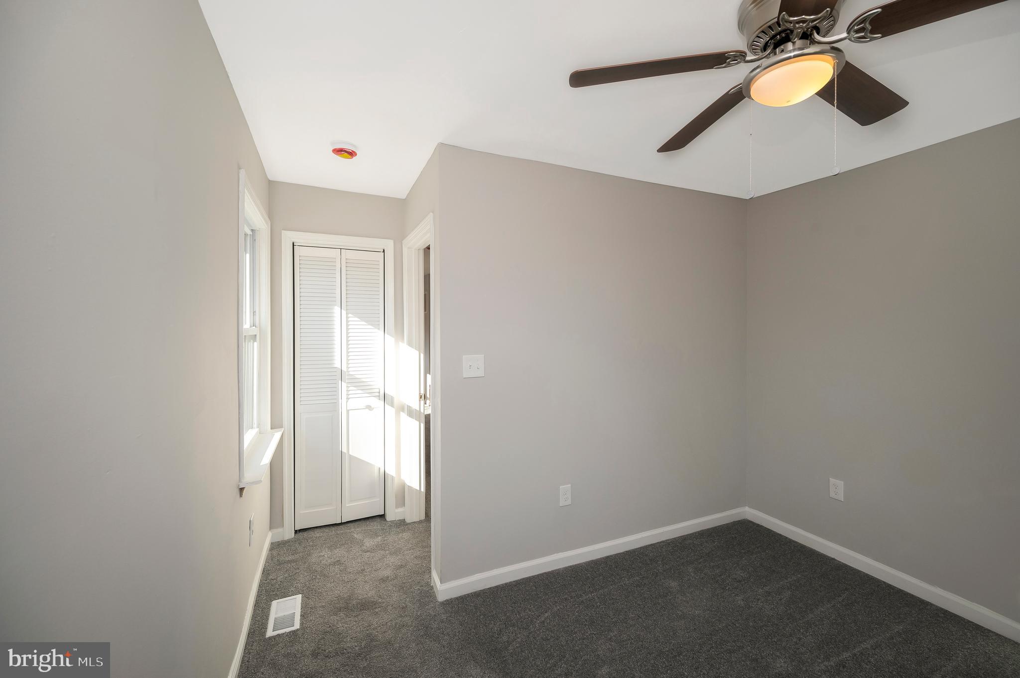 26348 Sunshine Road Ruther Glen, VA 22546 - Photo 38 of 56 an empty room with wooden floor and a window