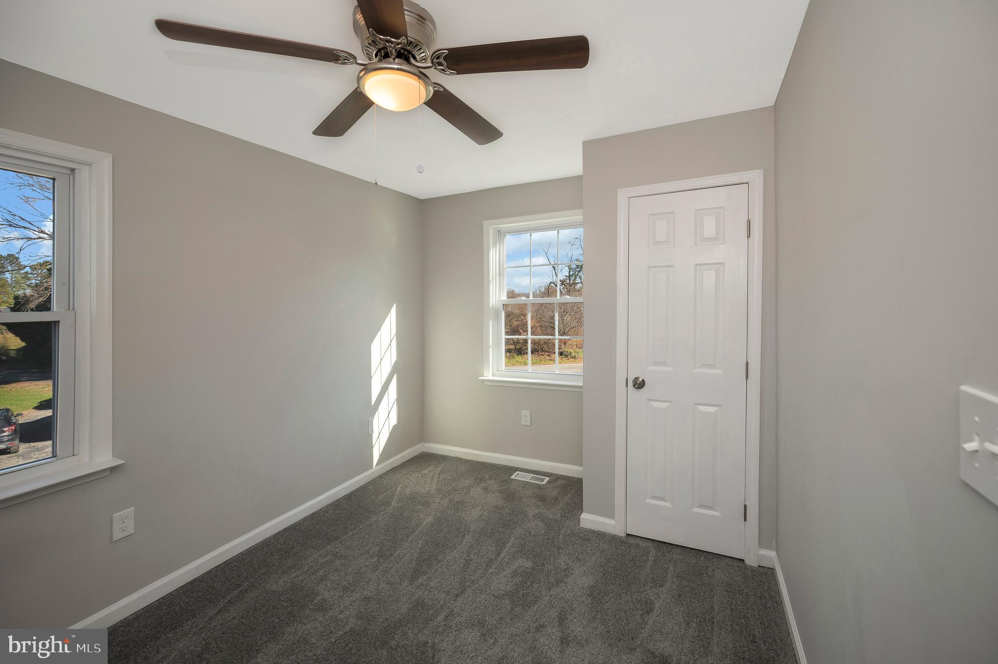 26348 Sunshine Road Ruther Glen, VA 22546 - Photo 39 of 56 an empty room with closet and a chandelier fan