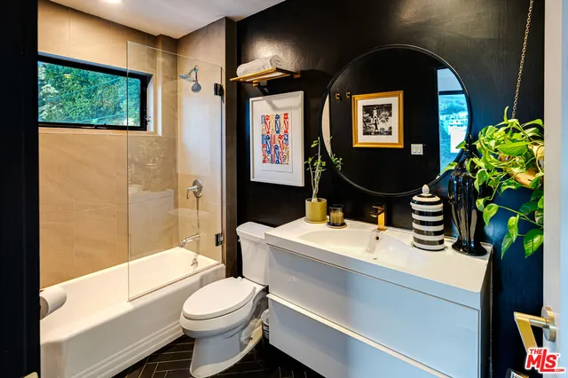 a bathroom with a sink a toilet and a shower