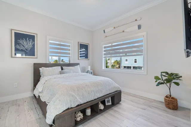 a bedroom with a bed and a potted plant