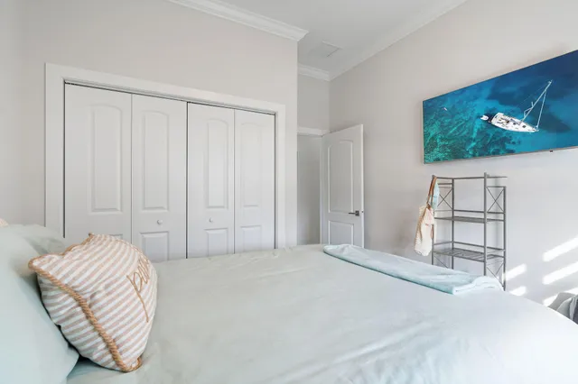 a bedroom with a bed and a painting on the wall