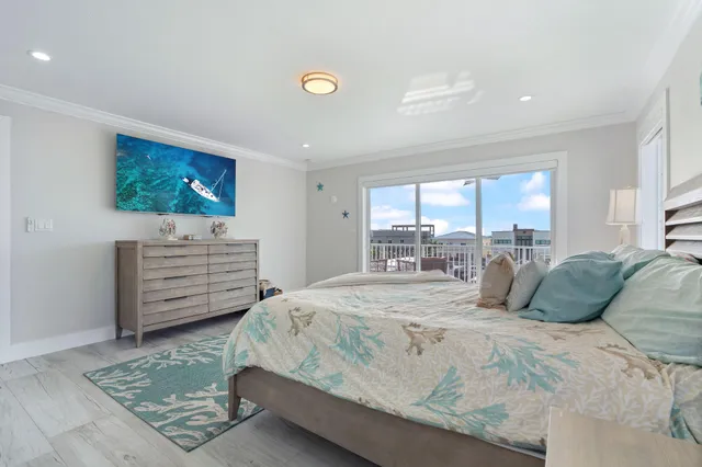 a bedroom with a large bed and a flat screen tv