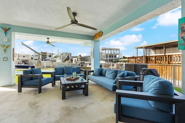 a outdoor living space with furniture and a view of kitchen