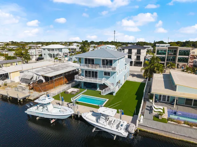 an aerial view of a house with a big yard