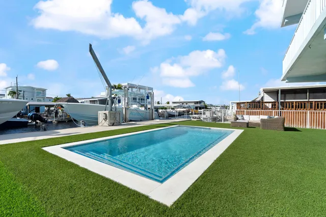 a view of a swimming pool with lawn chairs