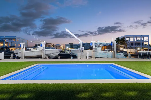 a room with pool table and chairs