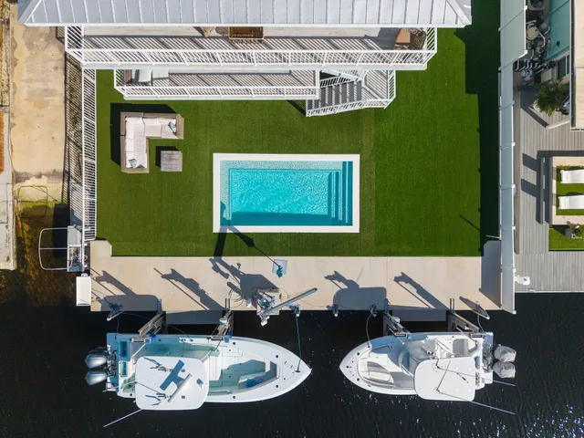 a view of a dining room with furniture wooden floor and a chandelier