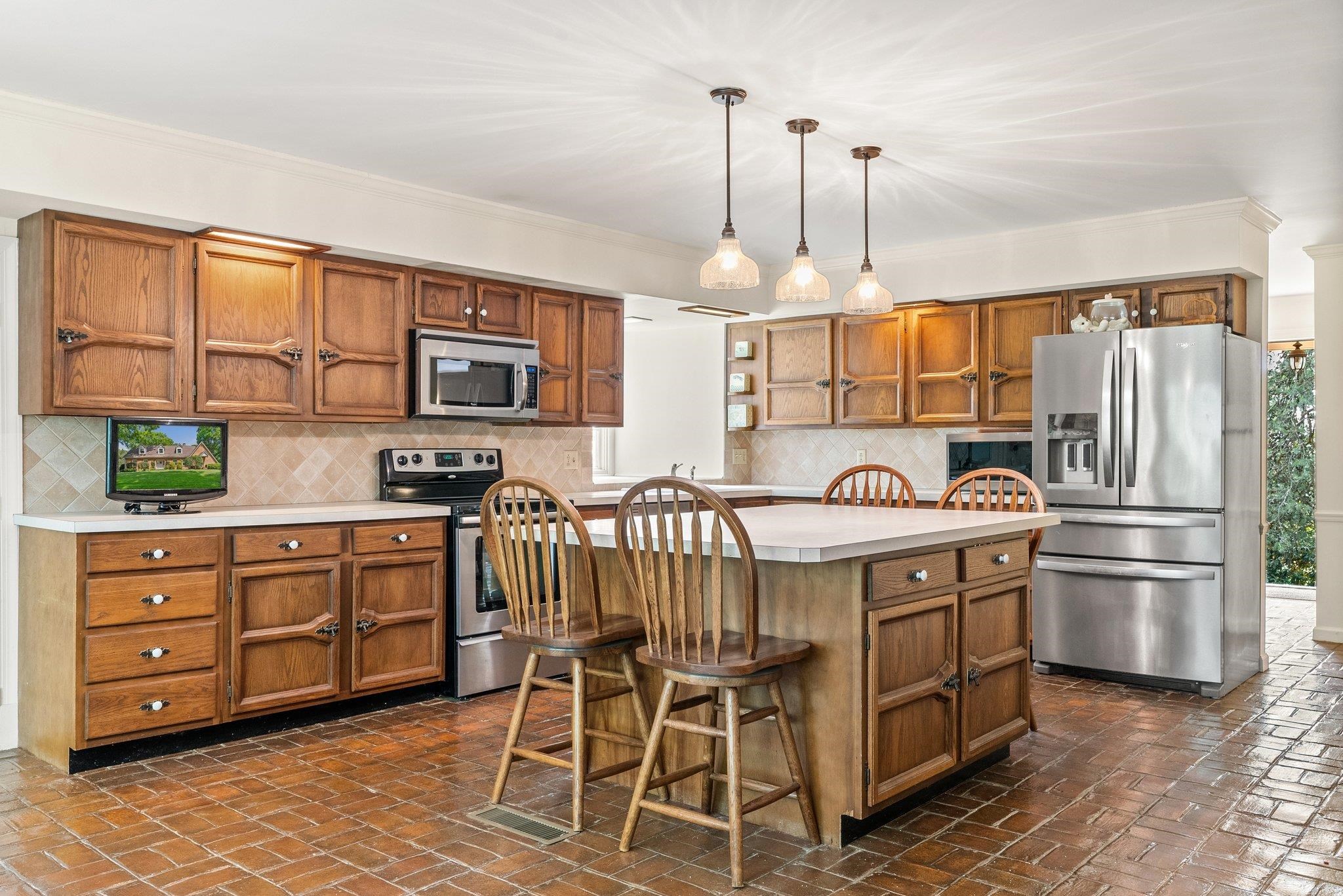 88 Roman Ridge Road Mount Sidney, VA 24467 - Photo 35 of 74 a kitchen with stainless steel appliances granite countertop a stove a refrigerator a oven a sink with a dining table and chairs