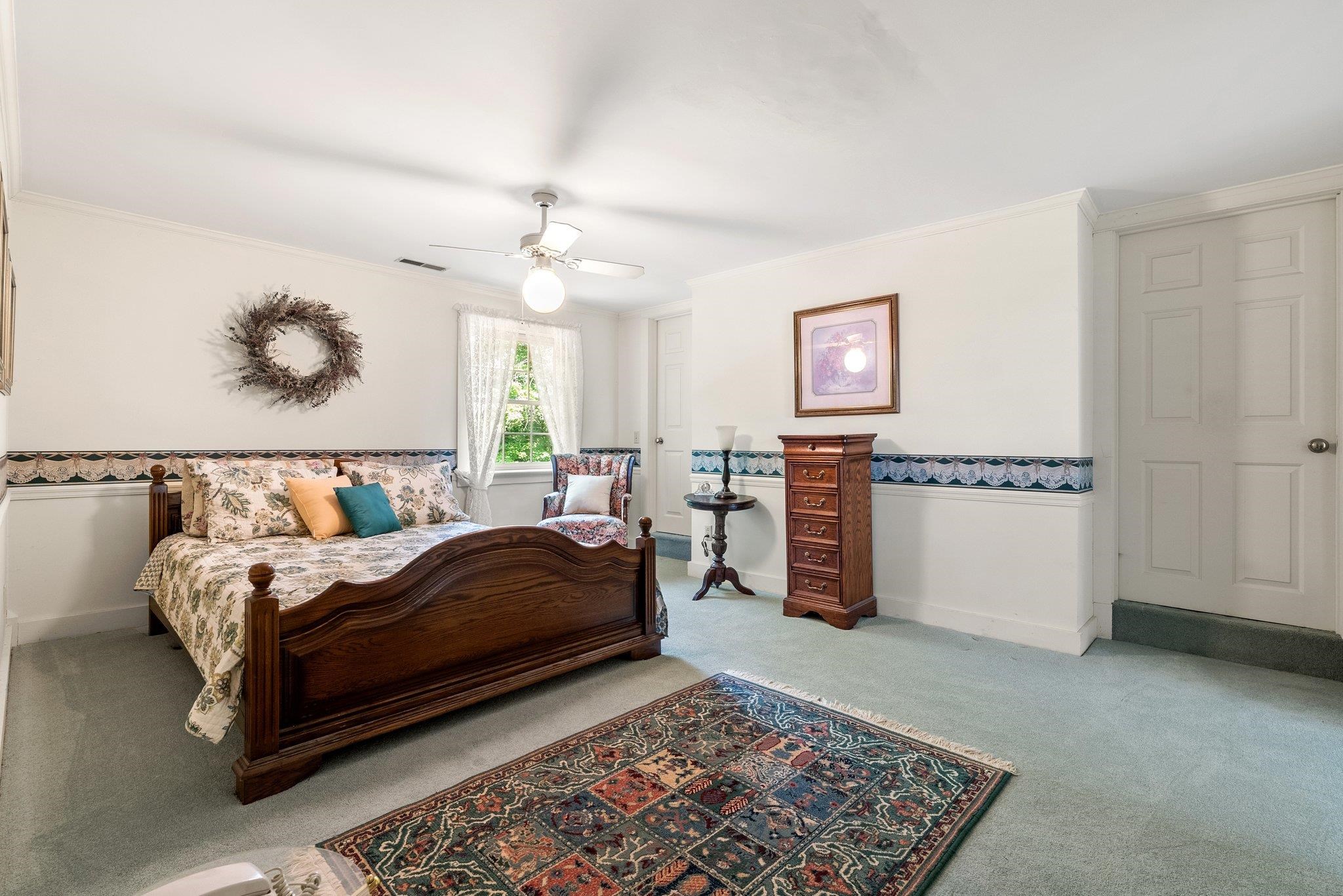 88 Roman Ridge Road Mount Sidney, VA 24467 - Photo 44 of 74 a bedroom with a bed and a chandelier