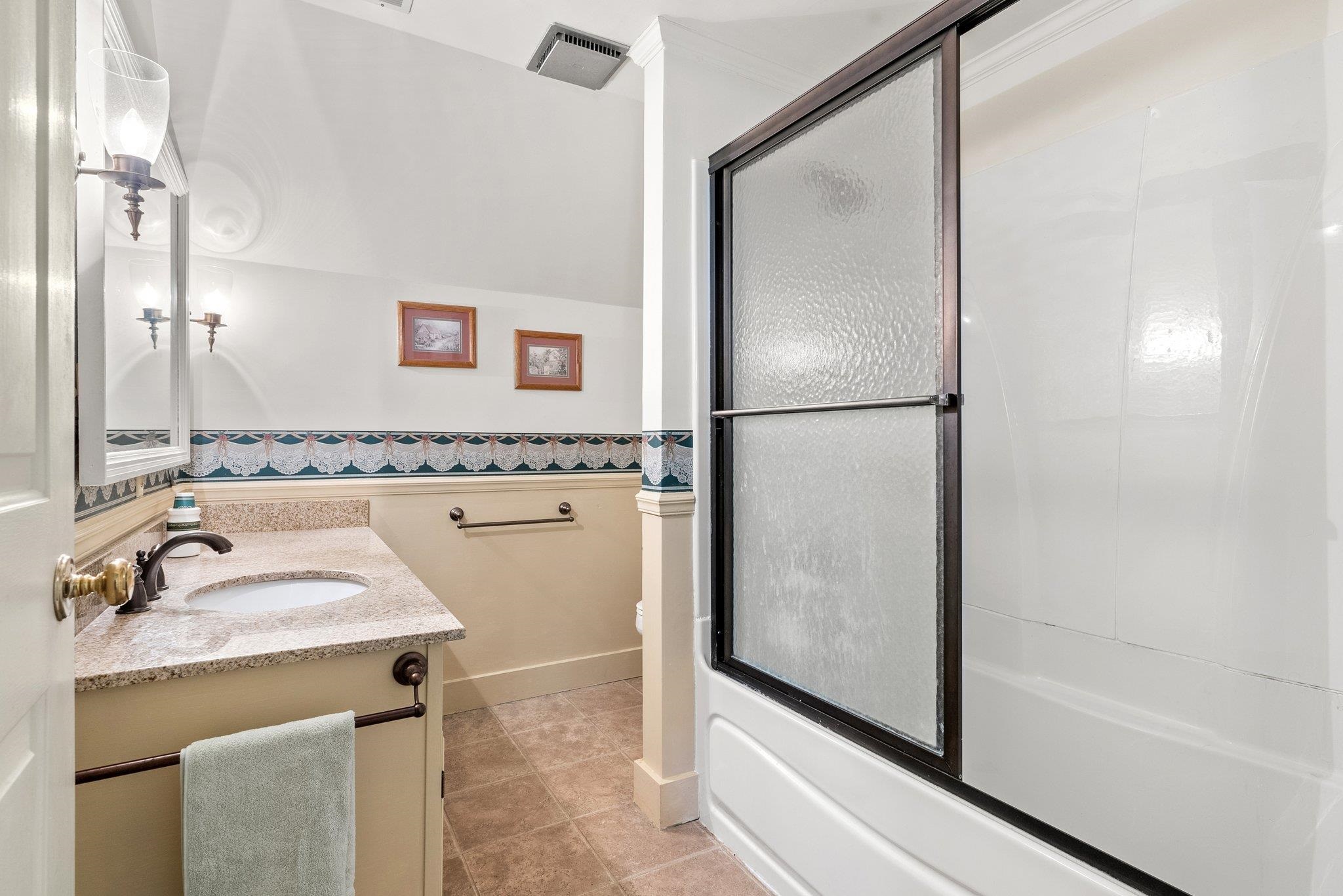 88 Roman Ridge Road Mount Sidney, VA 24467 - Photo 48 of 74 a bathroom with a granite countertop sink mirror and a bathtub