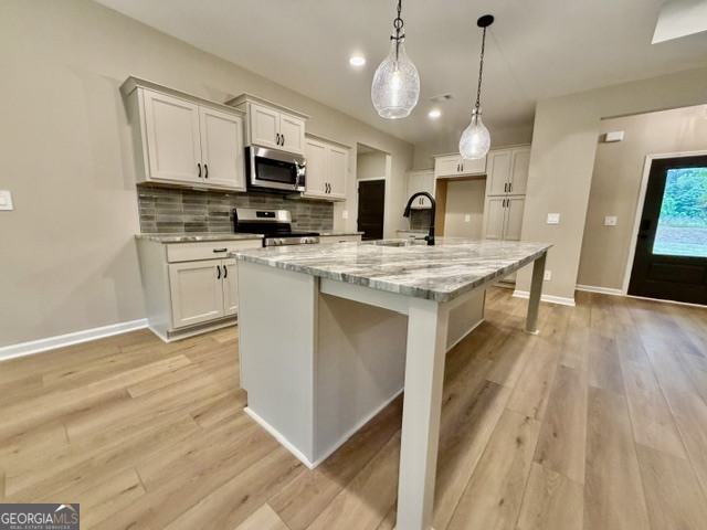 264 Robert Williams Road Greenville, GA 30222 - Photo 3 of 23 a kitchen with stainless steel appliances granite countertop a stove top oven a sink dishwasher and a microwave with wooden floor