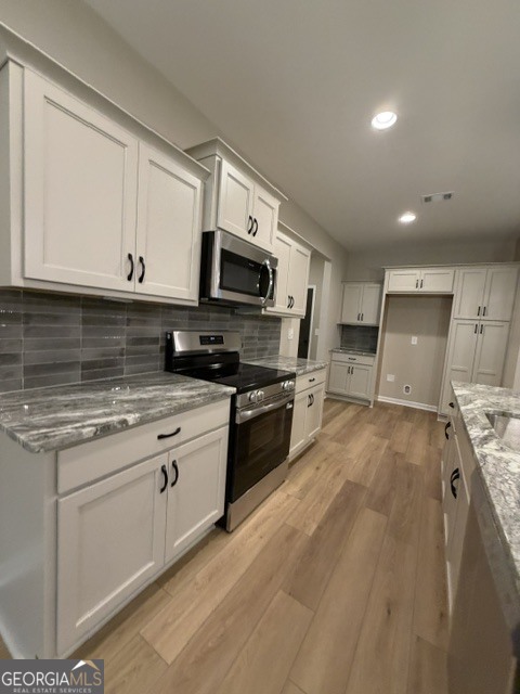 264 Robert Williams Road Greenville, GA 30222 - Photo 7 of 23 a kitchen with stainless steel appliances granite countertop a stove a sink and a microwave