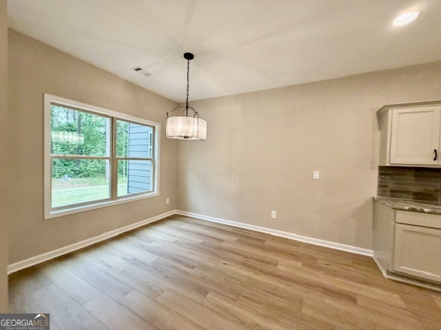 264 Robert Williams Road Greenville, GA 30222 - Photo 8 of 23 a view of empty room with wooden floor and kitchen view