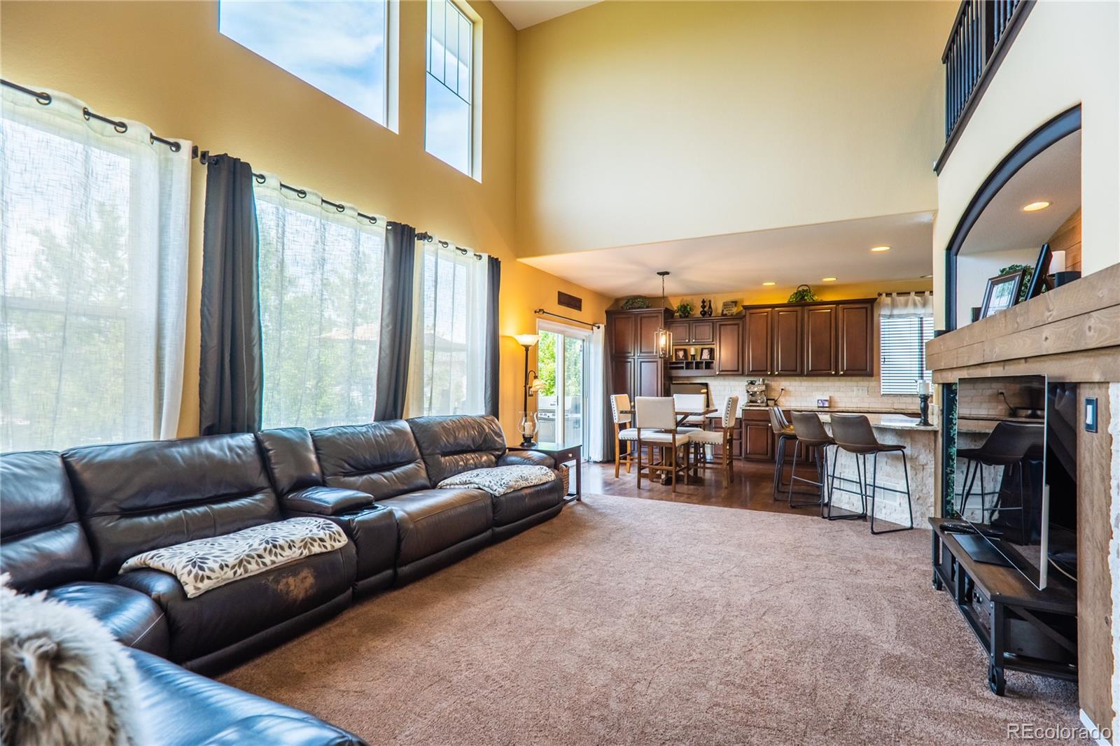 10857 Hickory Ridge Street Highlands Ranch, CO 80126 - Photo 11 of 40 a living room with furniture and a fireplace
