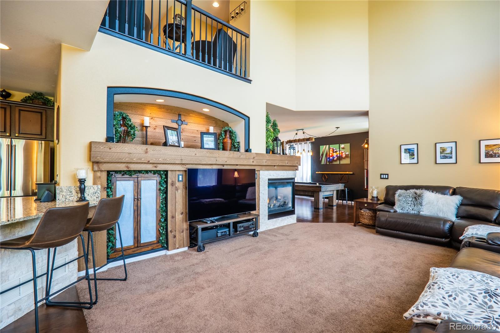 10857 Hickory Ridge Street Highlands Ranch, CO 80126 - Photo 14 of 40 a living room with furniture and a fireplace