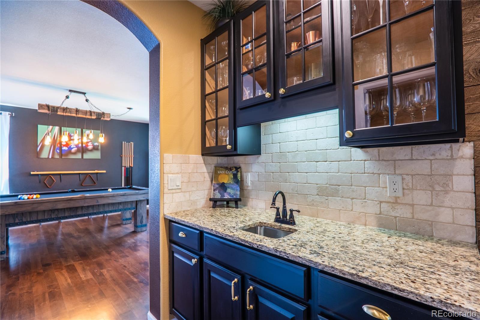 10857 Hickory Ridge Street Highlands Ranch, CO 80126 - Photo 17 of 40 a kitchen with a sink and a wooden floor