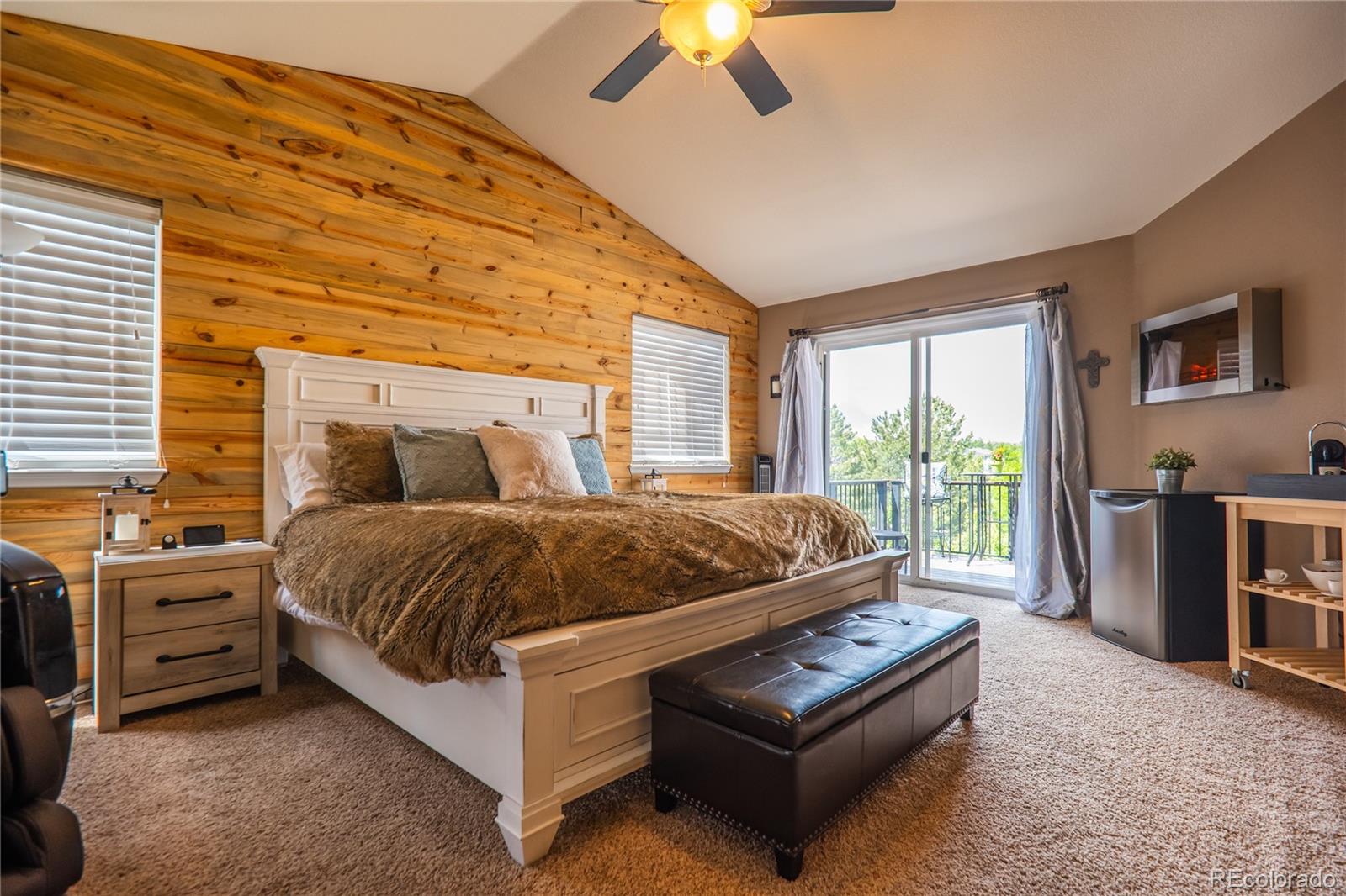 10857 Hickory Ridge Street Highlands Ranch, CO 80126 - Photo 18 of 40 a bedroom with a bed and a chandelier