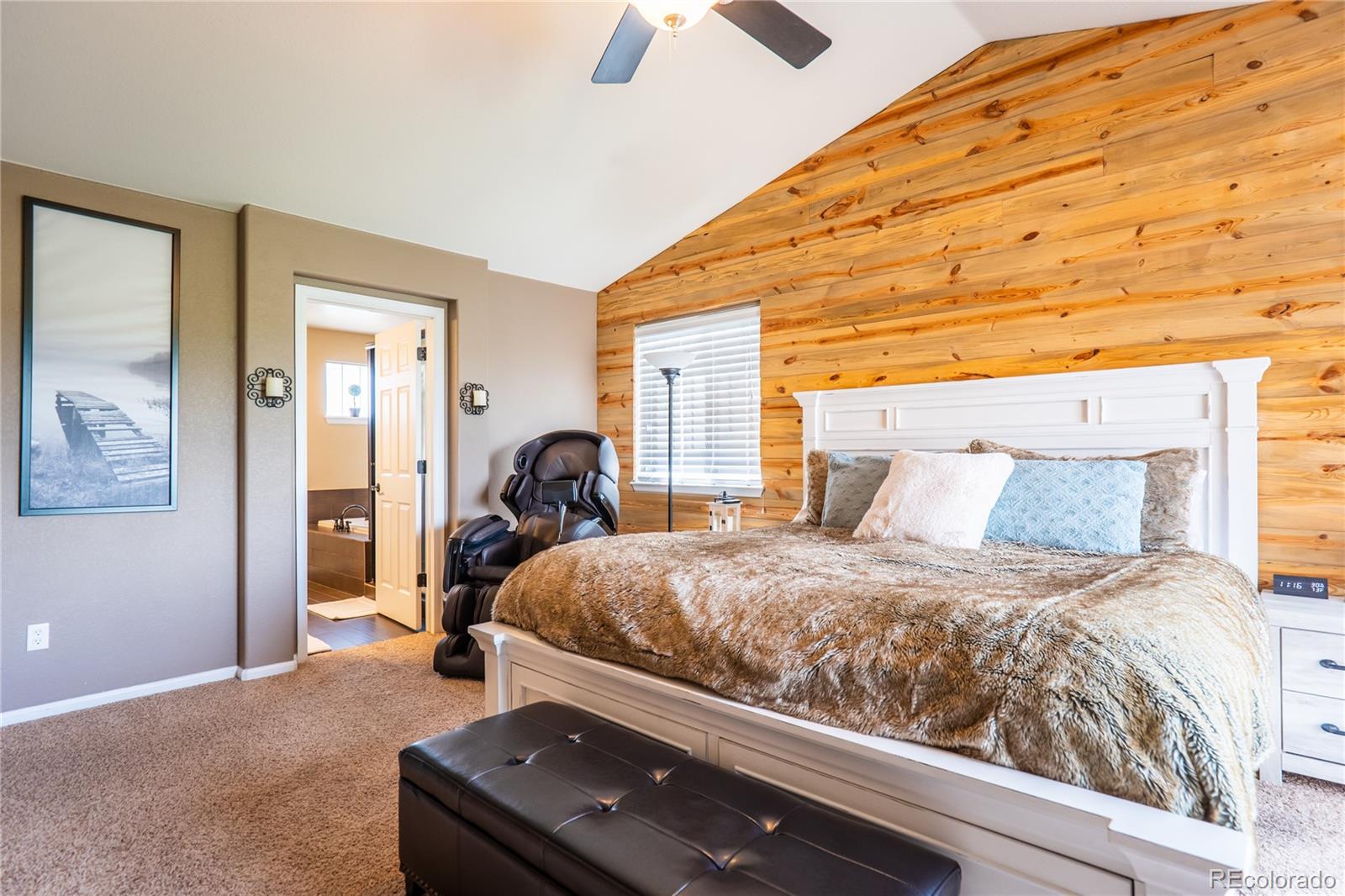 10857 Hickory Ridge Street Highlands Ranch, CO 80126 - Photo 19 of 40 a bed room with a bed and a chandelier