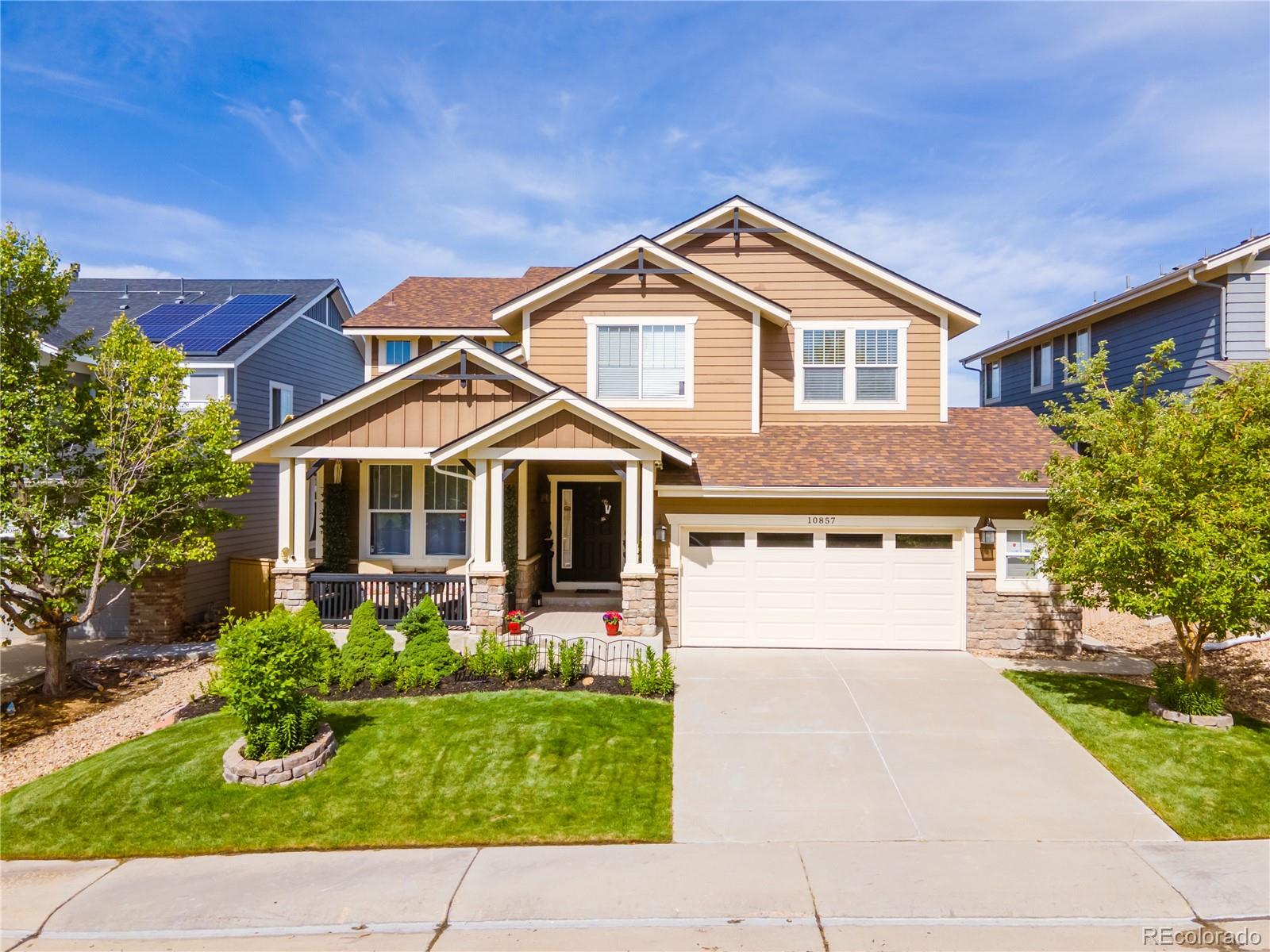 10857 Hickory Ridge Street Highlands Ranch, CO 80126 - Photo 2 of 40 a front view of a house with a yard