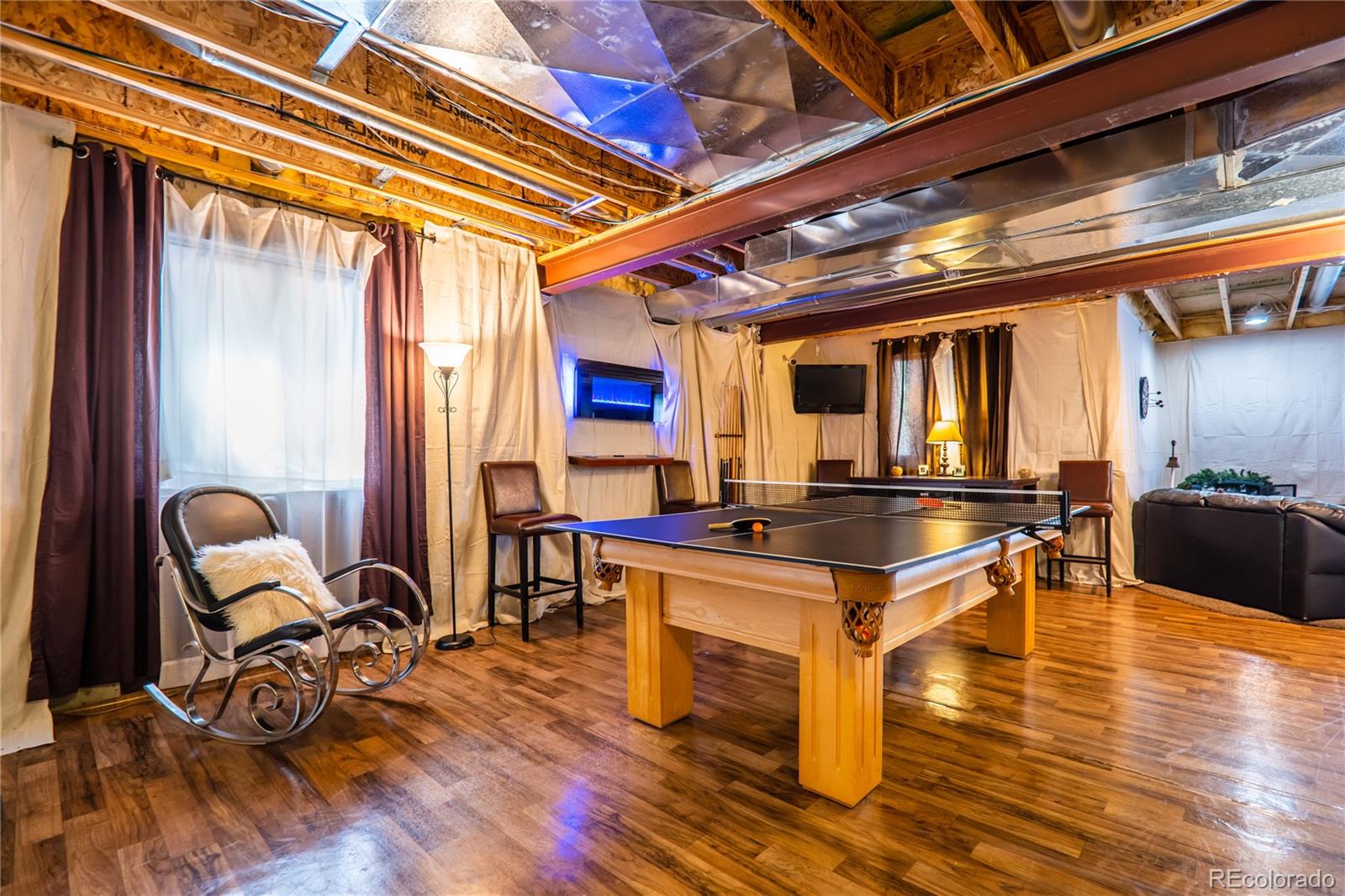 10857 Hickory Ridge Street Highlands Ranch, CO 80126 - Photo 27 of 40 a room with table chairs and wooden floor