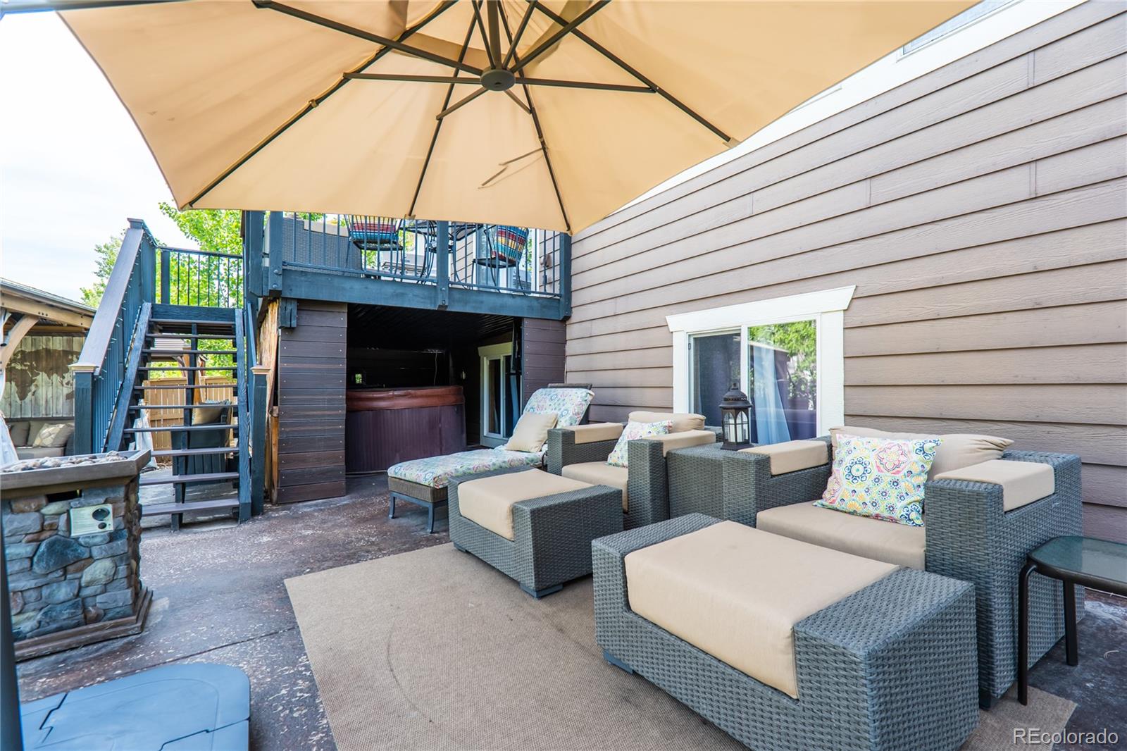 10857 Hickory Ridge Street Highlands Ranch, CO 80126 - Photo 35 of 40 a view of a patio with couches chairs and a fire pit