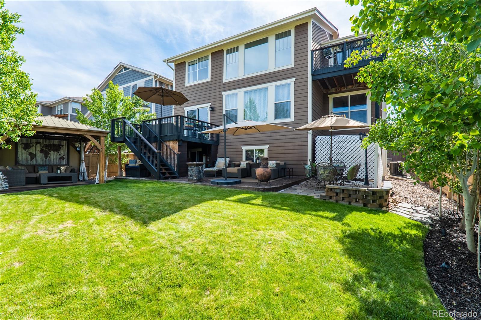 10857 Hickory Ridge Street Highlands Ranch, CO 80126 - Photo 36 of 40 a view of house with a yard and swimming pool