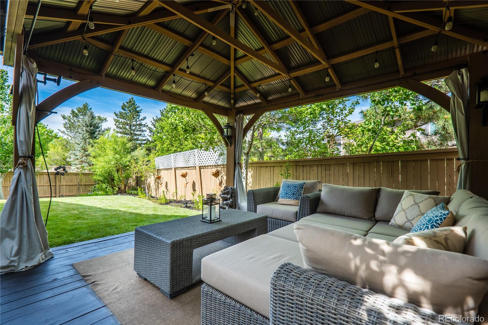 10857 Hickory Ridge Street Highlands Ranch, CO 80126 - Photo 38 of 40 a patio view with a table and chairs under an umbrella