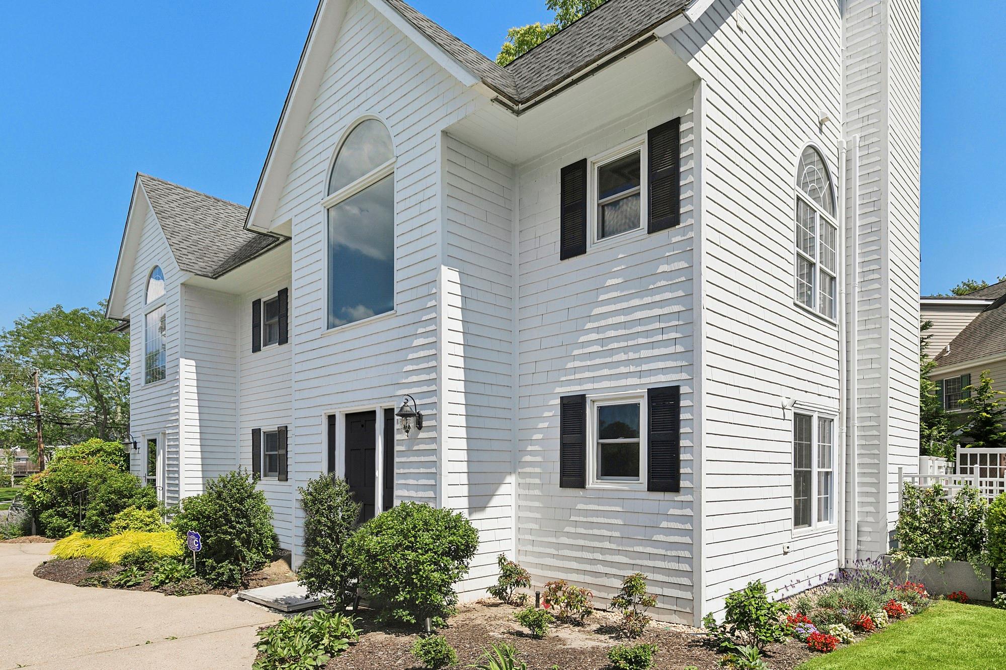 25 Mitchell Road, Unit 6 Westhampton Beach, NY 11978 - Photo 1 of 1 a view of a house with brick walls and potted plants