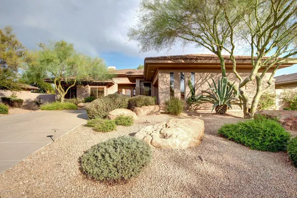 a view of a pathway with a garden