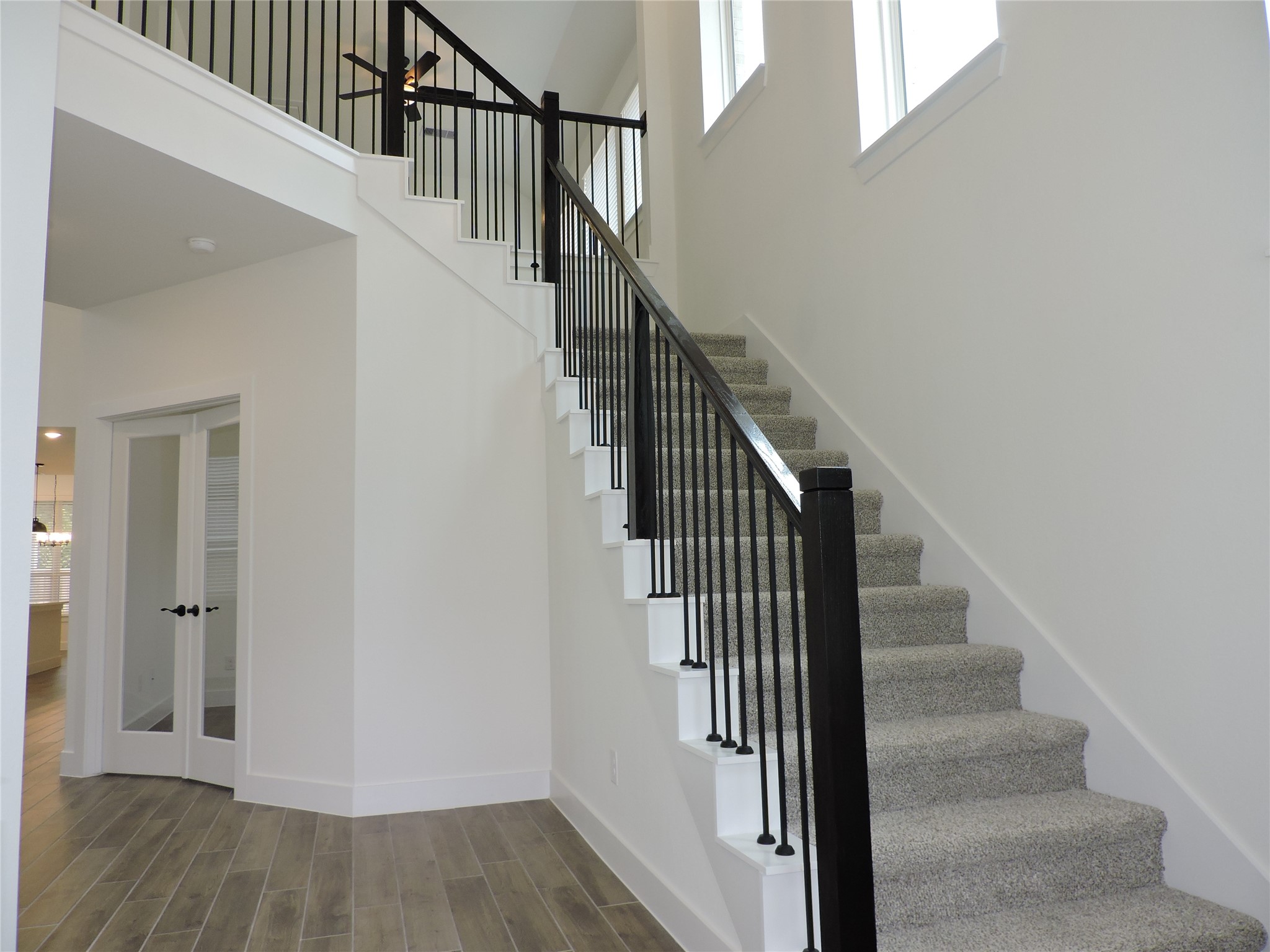 12853 Meadow Wind Way Conroe, TX 77302 - Photo 6 of 47 Lets look around the first floor, Ahead on the right, the French doors open to the Home Office or 5th bedroom with large walk in closet.