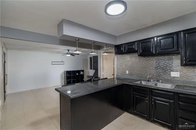 a kitchen with a sink and cabinets