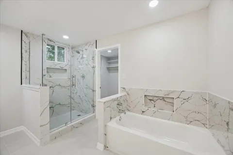 a bathroom with a bathtub and a shower