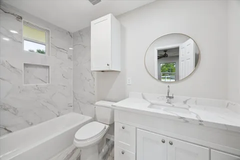 a bathroom with a toilet a sink and a mirror