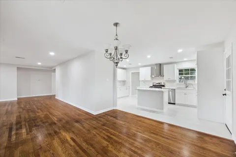 a open kitchen with kitchen island white cabinets and refrigerator