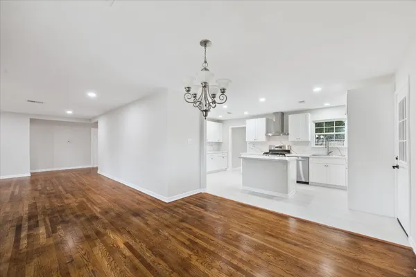 a open kitchen with kitchen island white cabinets and refrigerator