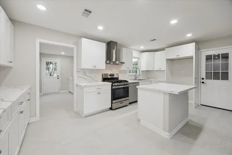 a kitchen with white cabinets and white appliances