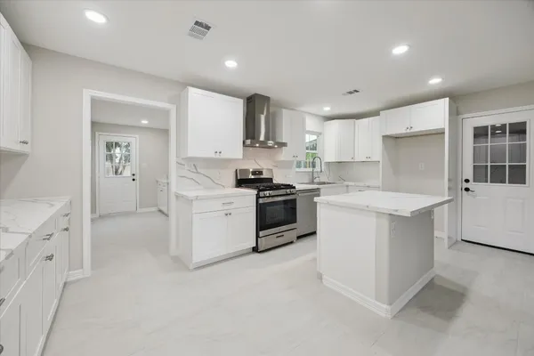 a kitchen with white cabinets and white appliances