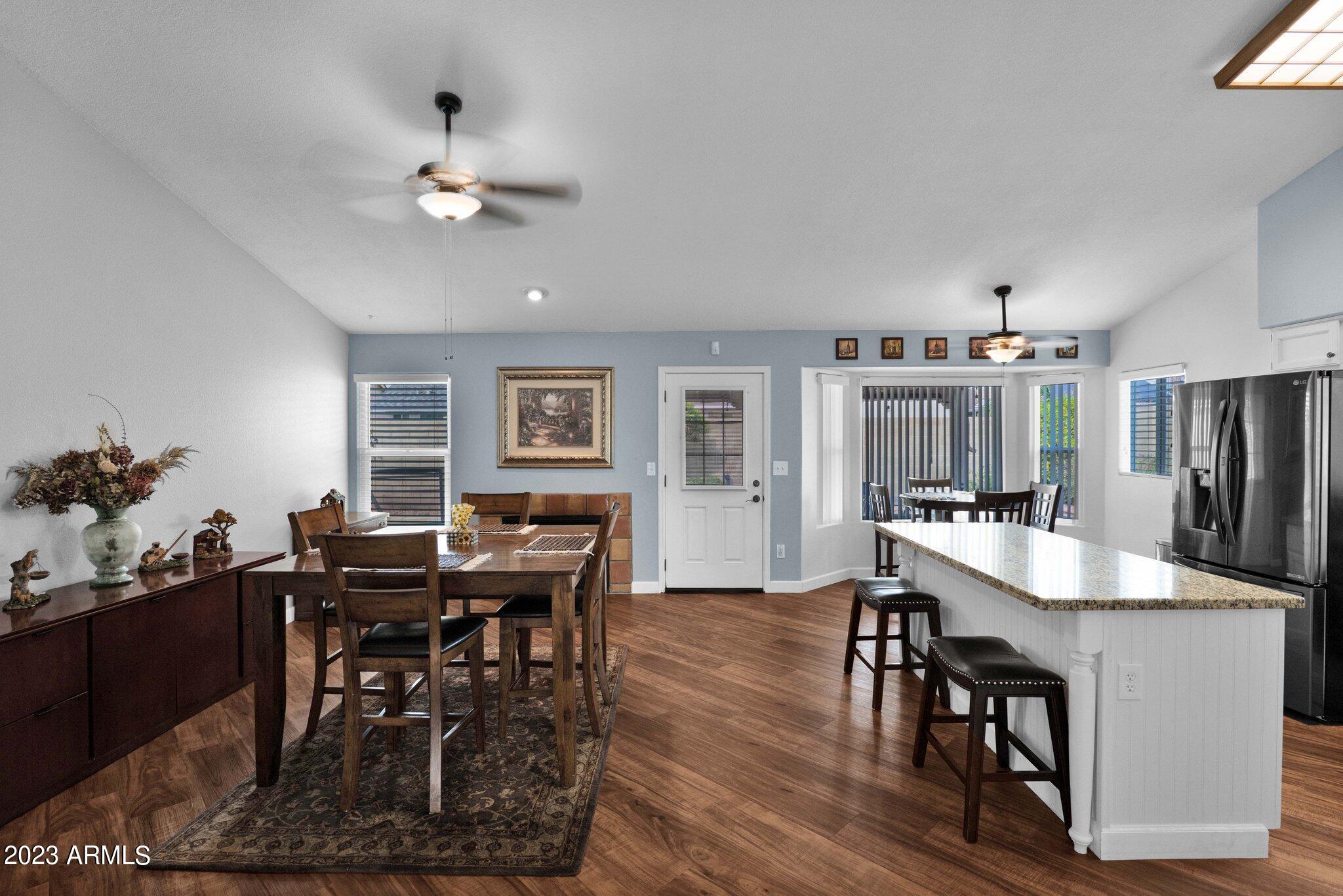 4338 East Douglas Avenue Gilbert, AZ 85234 - Photo 11 of 48 a view of a dining room with furniture and chandelier