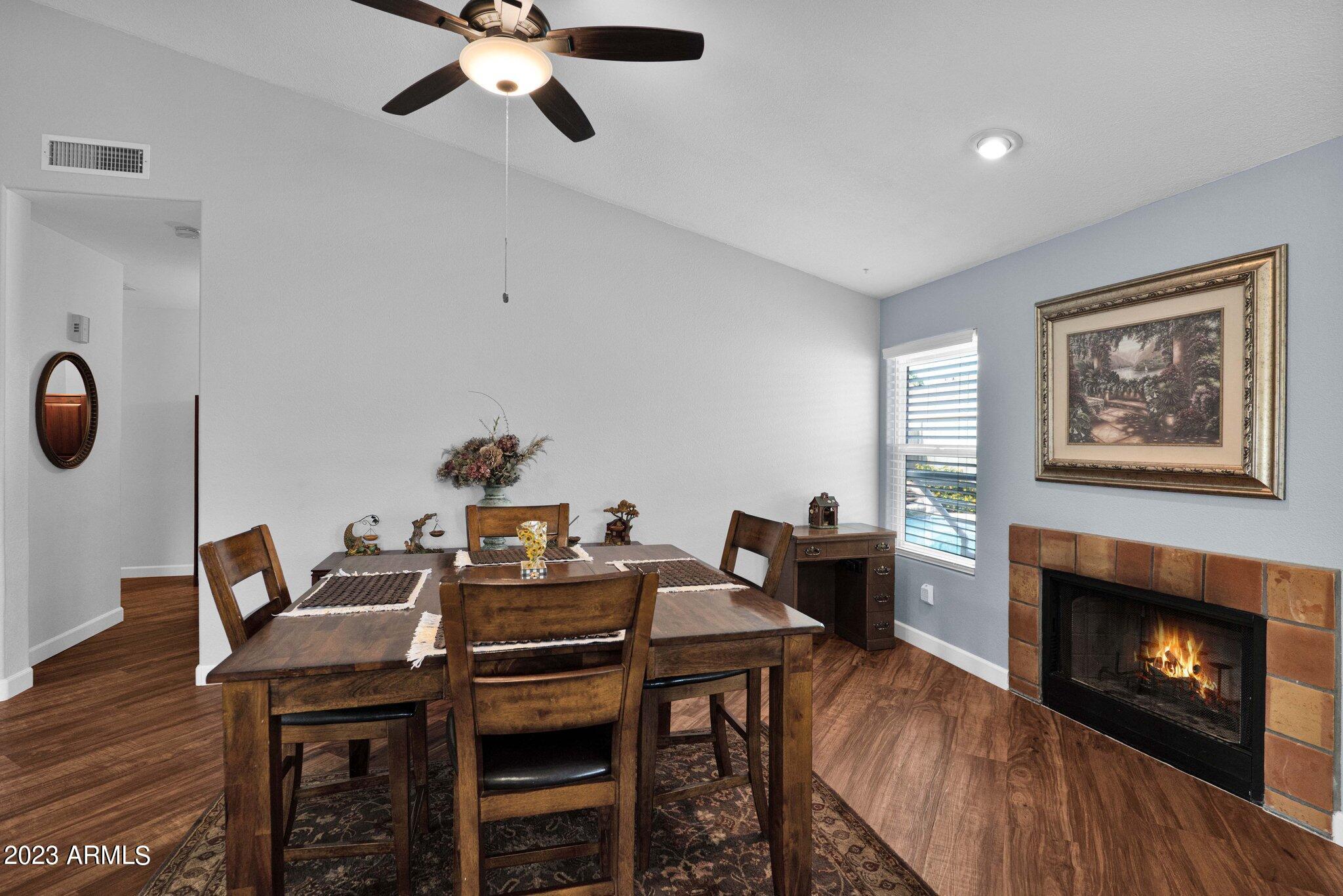 4338 East Douglas Avenue Gilbert, AZ 85234 - Photo 12 of 48 a view of a dining room with furniture and a fireplace